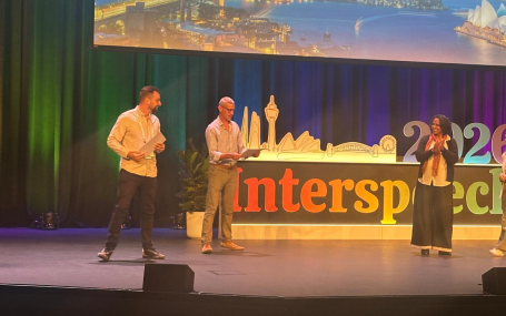 Angelo Dian on stage at a conference in receiving his award