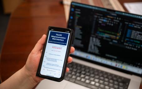 A picture of a mobile phone screen held in a hand