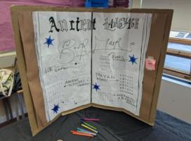 A display titled 'Ancient Language Book Marks'. The headings read Elvish Alphabet, Runic Alphabet, Mayan Alphabet, Ancient Alphabet + Numerals, and Hieroglyphic & Alphabet Meaning