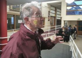 A man with a smiling face emoji on his right cheek