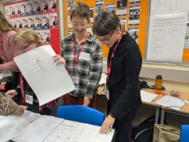 Two women looking down at a table of hieroglyphs