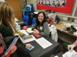 Florencia sitting behind a table, smiling at the camera.