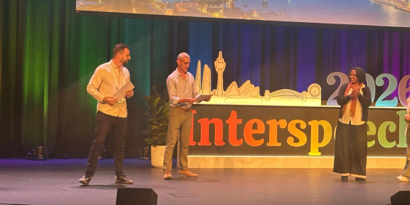 Angelo Dian on stage at a conference in receiving his award